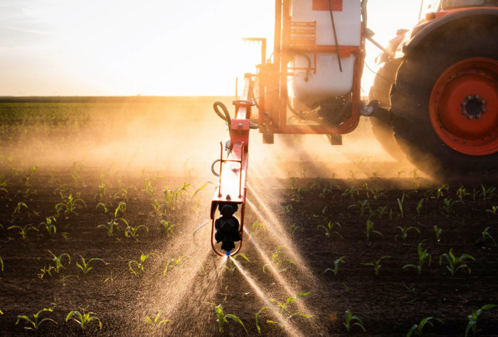 Tractor in field spraying field with ammonia, ammonia will be central to decarbonisation efforts 