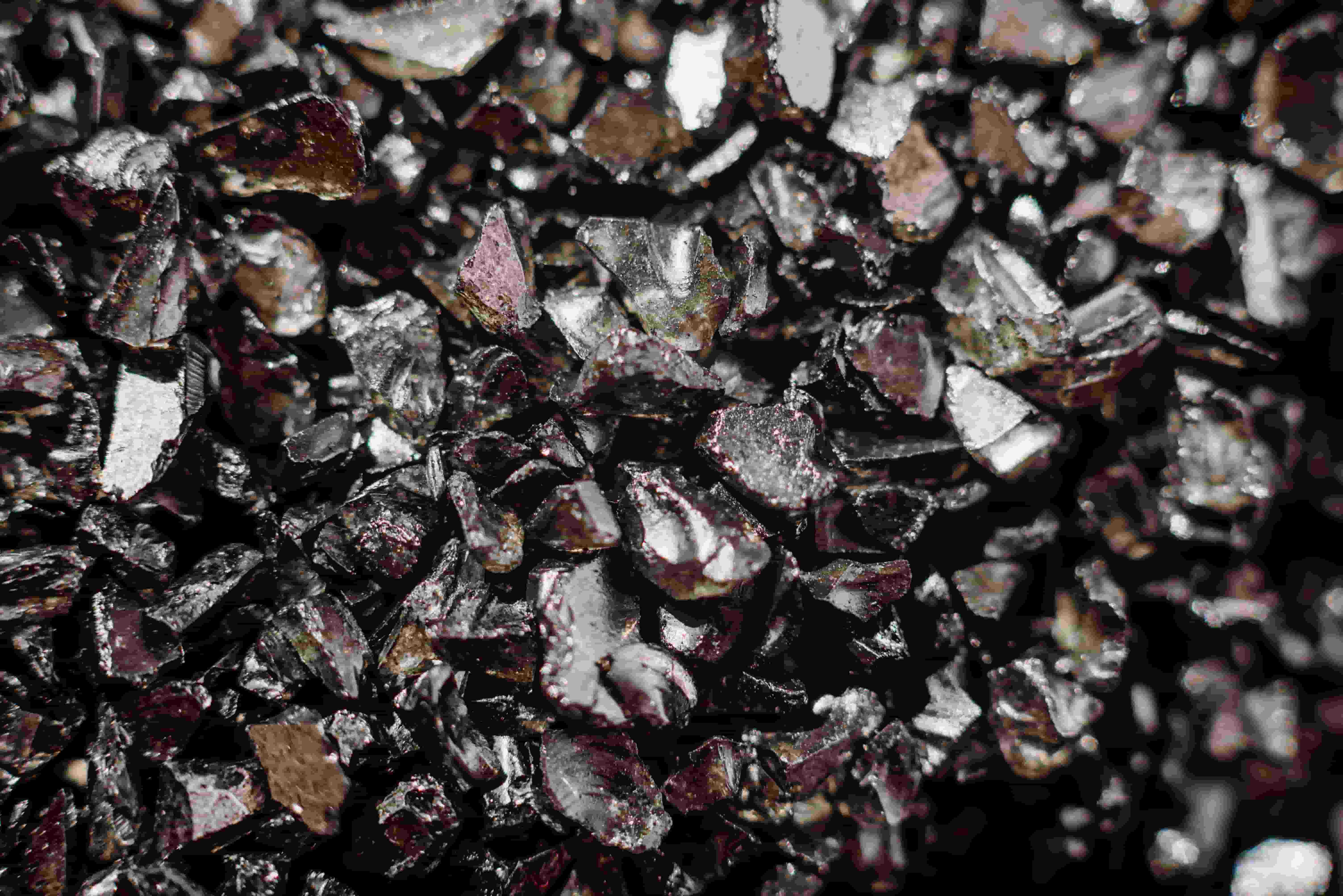 A stack of black rocks, illustrating the importance of rare earth elements in the evolving global market landscape.